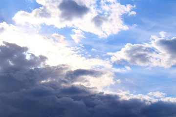 A beautiful cloudy sky, cumulus clouds and scorching sun. Background. Landscape.