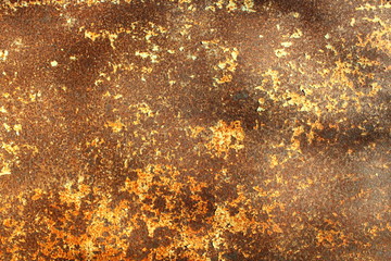 Old rusty sheet of iron with a yellow erased paint. Background. Texture.