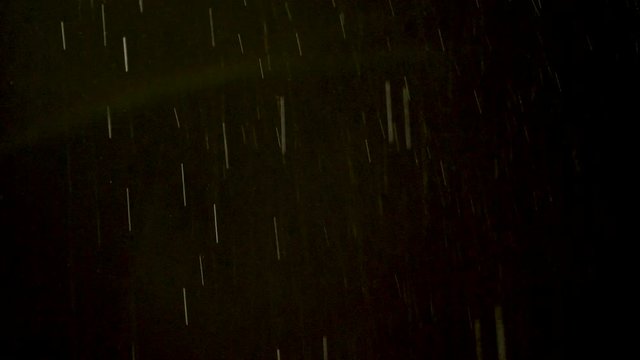 Rain or Snow Falling on Black Background.