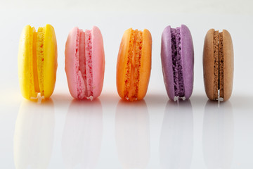 Colorful and tasty French Macarons on white background