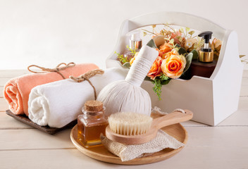 Fototapeta na wymiar Spa massage and body scrub with towels compress balls and flowers