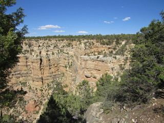 View of the Grand Canyon with a small cave opening in the distance on the far side, as seen from the south rim