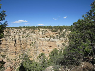View of the Grand Canyon with a small cave opening in the distance on the far side, as seen from the south rim