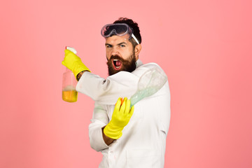 Bearded man with cleaning equipment. Cleaning concept. Portrait of angry bearded man with cleaning spray. Bearded man in work uniform. Cleaning advertising.