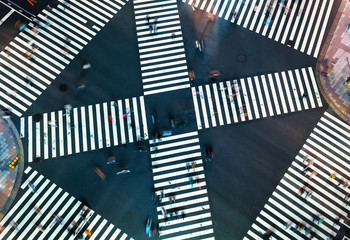 Aerial view of people crossing a big intersection in Ginza, Tokyo, Japan at night