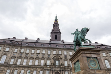 Fototapeta na wymiar Storm clouds over the Christiansborg Palace and Frederik VII statue.