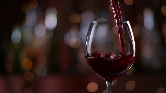 Red Wine Pouring into Glass in super slow motion. Shot with high speed cinema camera Phantom VEO 4K , 1000fps.