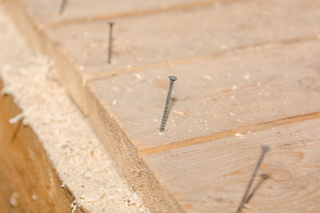 Screws in the boards. Screws in the board on the floor.