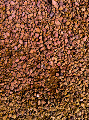 Orange gravel on a sunny day texture