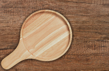 Circle wooden plate with handle.