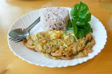 Mince pork omelet with rice on white dish