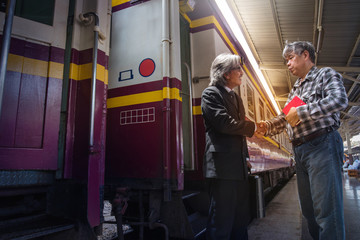 Fototapeta premium Manager who travels by train, Staff waiting for the key person at the station, hand shaking