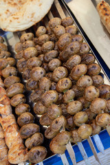 Shish kebab from fried potatoes on grill