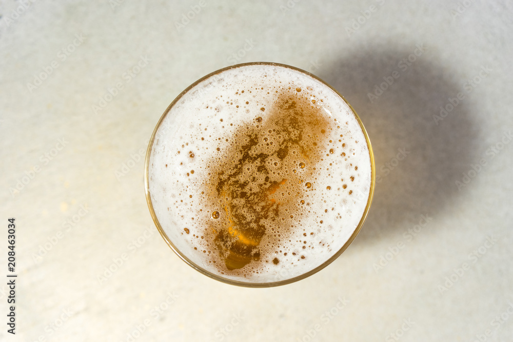 Poster glass of beer on a stone table background