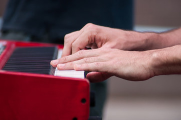closeup of hands of musician on piano keyboard