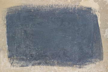 Painted gray rectangle on beige concrete surface.
