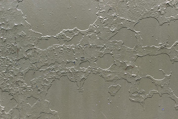 Grey metallic background with peeling and cracked paint.