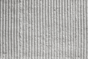 White wall with decorative plaster and vertical stripes. texture, background.