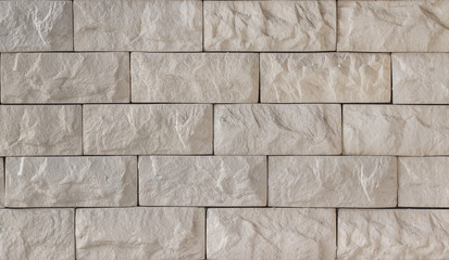 Wall of beige decorative brick