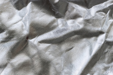 crumpled silver fabric, background.
