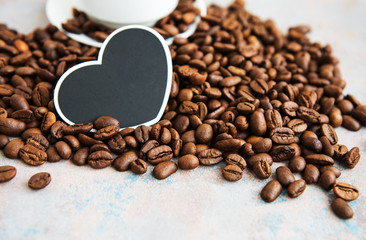 Coffee beans and card in the shape of a heart