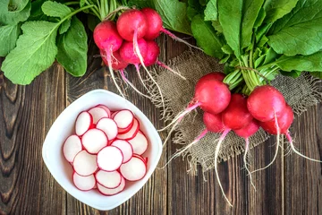 Fotobehang Fresh red radish on wooden background. © Natallia