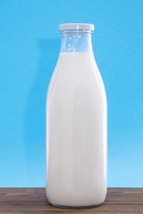 Fototapeta na wymiar milk bottle on wooden table