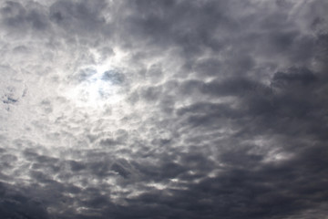 Fototapeta premium Through the dark clouds the sun shines a little