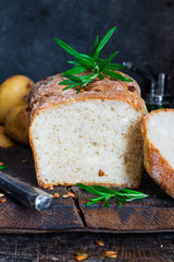 Home baked potato bread on rustic wooden table