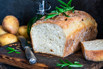 Home baked potato bread on rustic wooden table