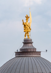 Fototapeta premium Gold statue of Saint Alexander on the dome of the Cathedral of Bergamo, Italy