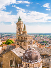 Fototapeta na wymiar Aerial view of the Basilica of Santa Maria Maggiore and Cappella Colleoni in Citta Alta of Bergamo, Italy on a sunny day