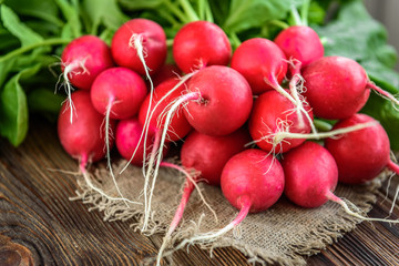 Fresh red radish on wooden background.