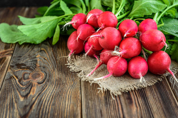 Fresh red radish on wooden background.