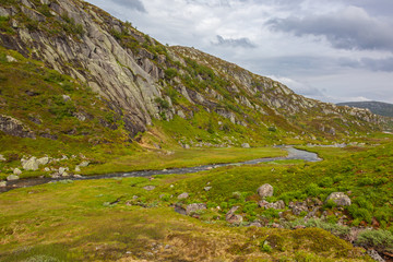 Mountain rivulet fall from the glaciers to the mountain valley on the Norwegian Scenic Route Ryfylke, Norway