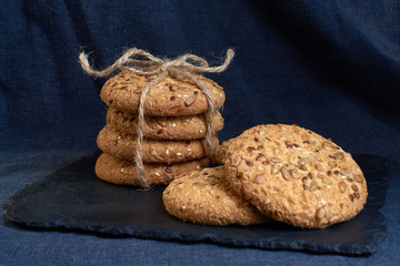 Savory cookies sprinkled with sesame seeds, sunflower on textile plaid