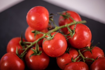 close up of fresh washed tomatoes on vine