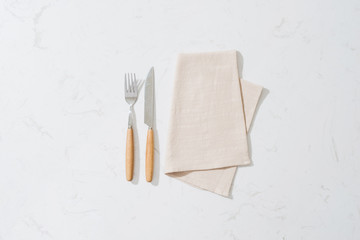 Napkin and cutlery on white background