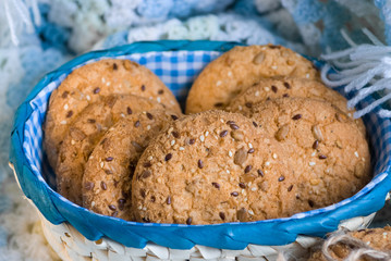 Savory cookies sprinkled with sesame seeds, sunflower on textile plaid