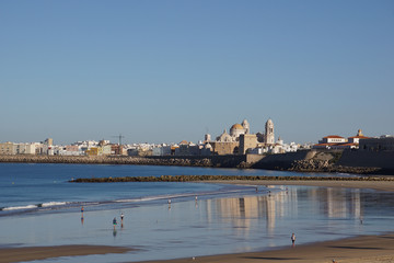 View of the waterfront of the city of Cadiz with Cadiz Cathedral reflecting in the water, Cadiz, Andalusia, Spain © RedHeadAnnika