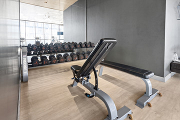 Dumbbell set and Equipment in modern gyms fitness, At luxury wood room