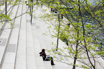 CHICAGO, ILLINOIS - May 19,2018: People rests on the steps the park of Chicago