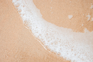 White Foam on Beach Sand