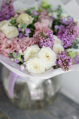 Floristry concept. Bouquet of beautiful flowers on gray table. Spring colors. the work of the florist at a flower shop.