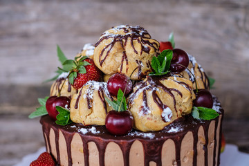 homemade profiterole cake with strawberries and cherries