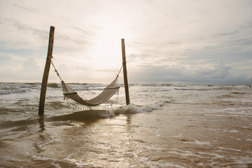 sandy beach with hammock, sunset at beautiful adventure beach