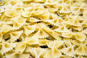 not cooked pasta Farfalle close-up are a bunch