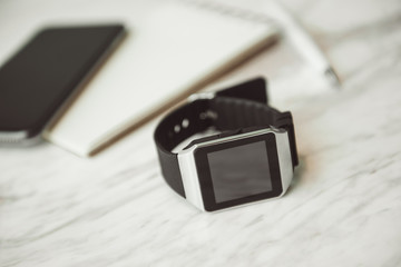 Unknown smart wrist watch laying on the table