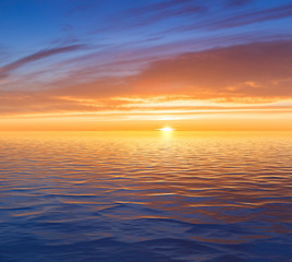 Beautiful sunrise over sea with reflection in water.