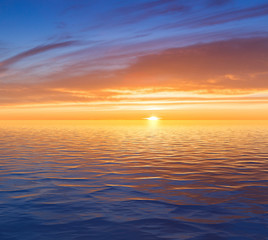 Obraz premium Beautiful sunrise over sea with reflection in water.